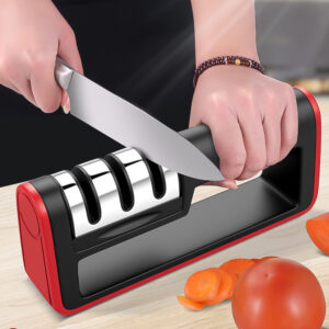 Manual 3-stage knife sharpener in use on kitchen counter with vegetables