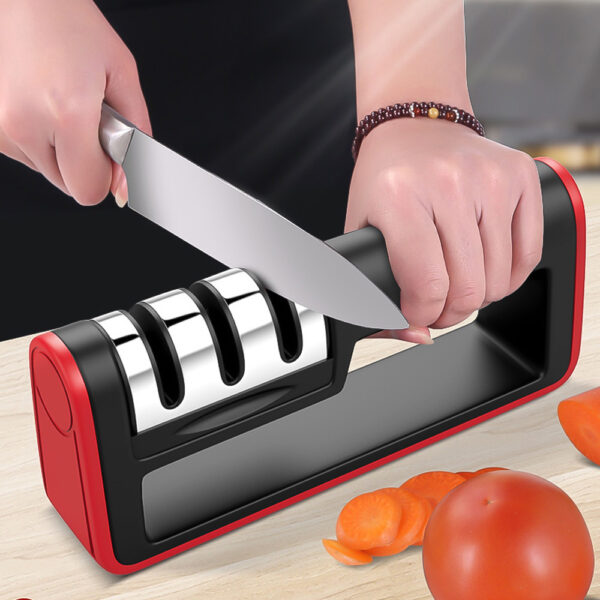 Manual 3-stage knife sharpener in use on kitchen counter with vegetables